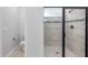 This bathroom boasts a modern walk-in shower with sleek tilework and glass door next to private toilet at 30369 Apricot Ave, Eustis, FL 32736