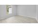 Neutral bedroom featuring modern flooring and a window at 30369 Apricot Ave, Eustis, FL 32736