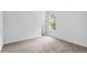 This is a comfortable bedroom with neutral carpeting, a window view, and a minimalist aesthetic at 30369 Apricot Ave, Eustis, FL 32736