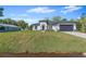 Beautiful one-story home with lush green lawn, dark gray roof, and modern landscaping at 30369 Apricot Ave, Eustis, FL 32736