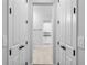 Neutral hallway leading to the modern laundry room at 30369 Apricot Ave, Eustis, FL 32736