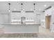 Bright kitchen featuring white cabinets, granite countertops, and modern pendant lighting at 30369 Apricot Ave, Eustis, FL 32736