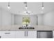 Modern kitchen featuring a large island with a granite countertop, a dual sink, and stainless steel appliances at 30369 Apricot Ave, Eustis, FL 32736