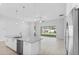 Open living room featuring granite countertop island, stainless steel appliances, and large sliding glass doors to backyard at 30369 Apricot Ave, Eustis, FL 32736