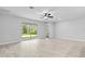 Bright living room with tile flooring, large sliding doors leading to the backyard, and recessed lighting at 30369 Apricot Ave, Eustis, FL 32736