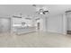 Open concept living room showcasing tile floors, recessed lighting, and seamless flow into the modern kitchen at 30369 Apricot Ave, Eustis, FL 32736