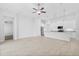 Bright living room with tile floors, ceiling fan, stainless steel appliances, and modern lighting at 30369 Apricot Ave, Eustis, FL 32736