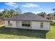 Back exterior view of home featuring sliding glass door and windows at 30369 Apricot Ave, Eustis, FL 32736