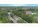 Panoramic aerial view of a residential community with lush greenery, community pool, and manicured streets at 3128 Stonehurst Cir, Kissimmee, FL 34741