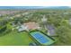 Breathtaking aerial view showcasing the community pool, clubhouse, and tennis courts nestled among lush greenery at 3128 Stonehurst Cir, Kissimmee, FL 34741