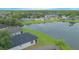 An aerial view showcasing the neighborhood's homes by a serene lake surrounded by lush green landscapes and trees at 3128 Stonehurst Cir, Kissimmee, FL 34741