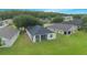 A neighborhood aerial view shows cozy homes, green lawns, and a tree-lined street for suburban charm and comfort at 3128 Stonehurst Cir, Kissimmee, FL 34741