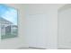 Bright bedroom featuring fresh paint, a double door closet, and natural light from a large window at 3128 Stonehurst Cir, Kissimmee, FL 34741