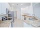Bright kitchen with stainless steel appliances and granite countertops at 3128 Stonehurst Cir, Kissimmee, FL 34741