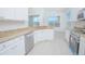 Open kitchen with stainless appliances, white cabinetry, and a lovely lake view at 3128 Stonehurst Cir, Kissimmee, FL 34741