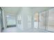 Screened patio with tile flooring and glass sliding doors, offering natural light and seamless transition to the outdoors at 3128 Stonehurst Cir, Kissimmee, FL 34741