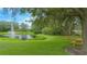 Picturesque pond with a fountain, surrounded by lush greenery, offering a serene and inviting community space at 3128 Stonehurst Cir, Kissimmee, FL 34741