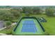 Aerial shot of a private, well-maintained community tennis court surrounded by mature landscaping at 3128 Stonehurst Cir, Kissimmee, FL 34741