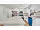 Modern kitchen with white cabinets, stainless steel appliances and large quartz countertop island at 3397 Janet St, Apopka, FL 32712
