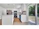Bright kitchen featuring white cabinets, stainless steel appliances and sliding door to the backyard at 3397 Janet St, Apopka, FL 32712