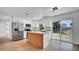 Stylish kitchen featuring white cabinets, stainless steel appliances, and sliding glass door to the back yard at 3397 Janet St, Apopka, FL 32712