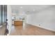 Bright, open-concept living space with hardwood floors seamlessly connecting to the kitchen area at 3397 Janet St, Apopka, FL 32712