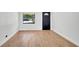 Bright living room featuring sleek wood flooring, a modern window, and a crisp white wall, creating a clean and inviting space at 3397 Janet St, Apopka, FL 32712