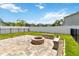 Backyard patio featuring stone fire pit, retaining walls, and private fencing at 3883 Crawley Down Loop, Sanford, FL 32773
