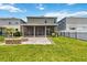 View of the backyard, showcasing a fire pit area, green lawn, and fenced perimeter at 3883 Crawley Down Loop, Sanford, FL 32773
