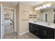 Bathroom featuring a double vanity, a large mirror, and access to an adjacent bedroom at 3883 Crawley Down Loop, Sanford, FL 32773