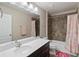 Bright bathroom featuring a vanity with a single sink and a shower with brown tiling at 3883 Crawley Down Loop, Sanford, FL 32773
