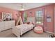 Soft pink bedroom featuring two windows, a twin bed, and cute decorations at 3883 Crawley Down Loop, Sanford, FL 32773