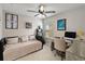 Neutral bedroom space featuring a daybed, desk, ceiling fan and natural light at 3883 Crawley Down Loop, Sanford, FL 32773