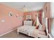 Soft pink bedroom featuring a twin bed, teepee, dresser, and whimsical decor at 3883 Crawley Down Loop, Sanford, FL 32773