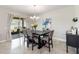 Bright dining room with modern lighting, a large dining table, sliding glass doors, and access to the lanai at 3883 Crawley Down Loop, Sanford, FL 32773
