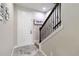 Bright entryway featuring stylish gray tile flooring, staircase with dark wood and iron railing, and modern decor at 3883 Crawley Down Loop, Sanford, FL 32773