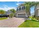 Charming two-story home featuring a two-car garage, brick paver driveway, and well-maintained landscaping at 3883 Crawley Down Loop, Sanford, FL 32773