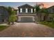 Charming home featuring a manicured front lawn and driveway, complete with an attached garage at 3883 Crawley Down Loop, Sanford, FL 32773