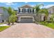Charming home featuring a manicured front lawn and driveway, complete with an attached garage at 3883 Crawley Down Loop, Sanford, FL 32773
