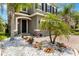 Inviting front entrance featuring a black door, stone accents, and beautiful landscaping with white rock at 3883 Crawley Down Loop, Sanford, FL 32773