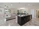 Open floor plan featuring a stylish kitchen with island, modern appliances, and seamless connection to the living spaces at 3883 Crawley Down Loop, Sanford, FL 32773