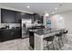 Modern kitchen features black cabinets, stainless steel appliances, and a large island with marble countertop at 3883 Crawley Down Loop, Sanford, FL 32773