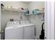 A dedicated laundry room with appliances and storage shelving for convenience at 3883 Crawley Down Loop, Sanford, FL 32773
