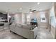 Bright and open living area featuring a comfortable sofa and seamless flow to the dining and kitchen spaces at 3883 Crawley Down Loop, Sanford, FL 32773