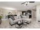 Open-concept living room showcasing modern furnishings, stylish decor, and seamless transition to the kitchen and dining areas at 3883 Crawley Down Loop, Sanford, FL 32773
