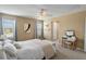 Bright bedroom featuring a ceiling fan and makeup vanity, with neutral walls and plush bedding at 3883 Crawley Down Loop, Sanford, FL 32773