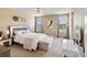 Bright bedroom featuring large windows, neutral walls, ceiling fan and contemporary decor at 3883 Crawley Down Loop, Sanford, FL 32773