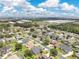 Wide aerial shot of the neighborhood, highlighting its proximity to business parks and green spaces under a bright sky at 4221 Kezar Ct, Belle Isle, FL 32812