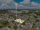 Highlighted property in an aerial view of a suburban neighborhood with tree-lined streets and nearby commercial buildings at 4221 Kezar Ct, Belle Isle, FL 32812