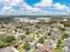 High-angle aerial view of a well-planned neighborhood with homes, roads, and commercial buildings in the distance at 4221 Kezar Ct, Belle Isle, FL 32812